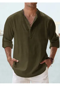 Detail of olive green cotton Henley shirt with half-button placket and rolled sleeves