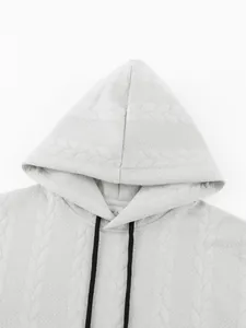 Detail view of jacquard textured grey men's hoodie with black drawstrings