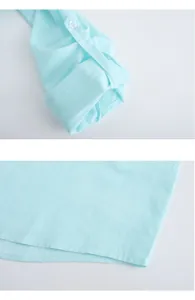 Detailed view showing the buttoned cuff and smooth hem of a mint blue men's casual shirt.