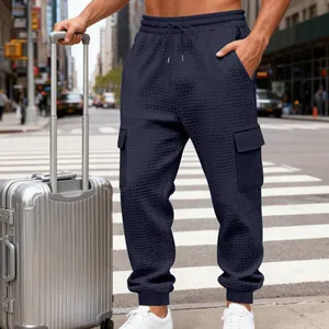 Dettaglio dei pantaloni sportivi da uomo in maglia a nido d'ape blu navy con tasche cargo.
