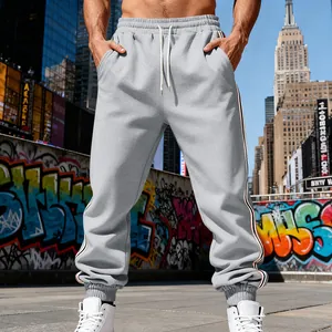 Dettaglio dei pantaloni sportivi grigi da uomo foderati in pile con strisce laterali.