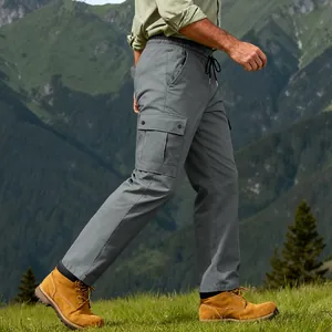 Men's grey quick-dry cargo pants for outdoor hiking, shown in a mountain scene context.