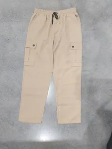 Detail view of khaki cargo pants with elastic drawstring waist and side pockets