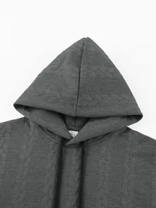 Detail view of a heavyweight grey men's hoodie showing the jacquard chevron texture