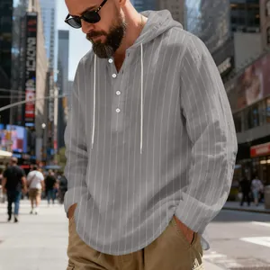 Detail view of a gray vertical striped linen hoodie with white buttons and drawstrings
