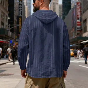 Back view of men's navy blue pinstripe linen hooded pullover in urban street scene