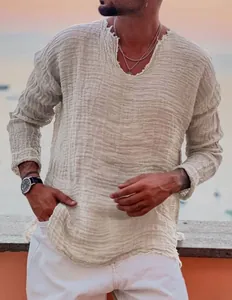 Close-up of men's frayed V-neck cotton shirt with crinkled texture in beige color