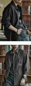 Detailed view of a men's charcoal grey vintage workwear shirt in a library setting.