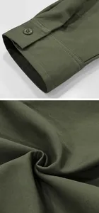 Close-up of army green cotton twill shirt cuff and durable vintage fabric texture.