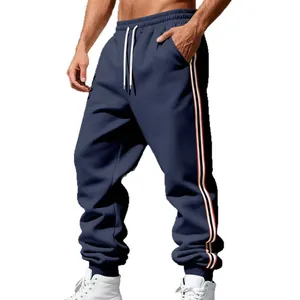 Pantaloni sportivi uomo blu navy foderati in pile con strisce laterali per autunno.