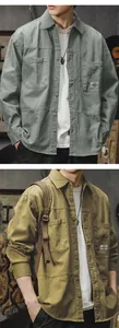 Detail of vintage men's cotton cargo shirt with pockets and washed fabric texture.