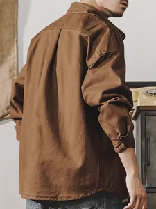 Vintage men's cotton military workwear shirt in brown, back view lifestyle shot