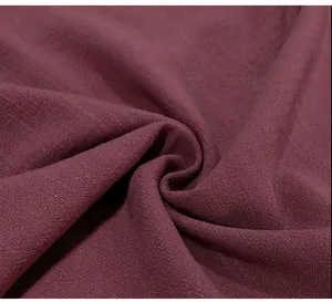 Close-up detail showing the breathable burgundy fabric texture of this casual men's shirt