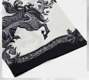 Close-up of black and white ink-wash horse print and baroque border on men's shirt