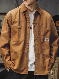 Detailed view of a men's vintage brown cotton long-sleeve workwear shirt on a model