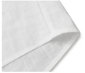 Close-up of white breathable fabric texture and neat stitching on men's shirt hem