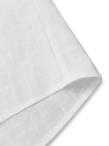 High quality close-up of white breathable linen-textured shirt hem with fine stitching