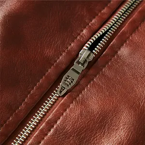 Detail of durable metal zipper on a brown faux leather motorcycle jacket for men