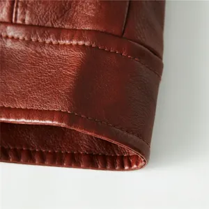 Macro detail of brown leather motorcycle jacket showing high-quality stitching and texture