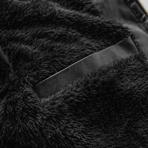 Detail of black fleece-lined faux leather jacket showing warm plush interior texture.