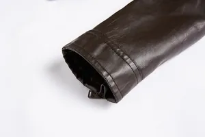 Close-up of men's dark brown PU leather jacket sleeve cuff with zipper detail.
