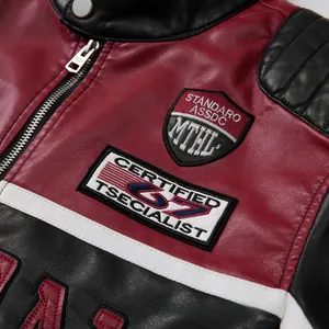 Close-up of embroidery patches on a red and black color-blocked racing leather jacket