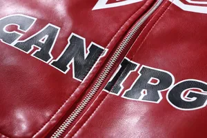 Macro detail of red PU leather motorcycle jacket showing texture and metal zipper