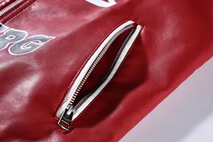 Detailed close-up showing the zipper pocket on a red faux leather biker jacket with print.