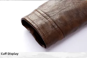 Detailed close-up showing the reinforced double-stitched cuff on a brown vintage leather jacket