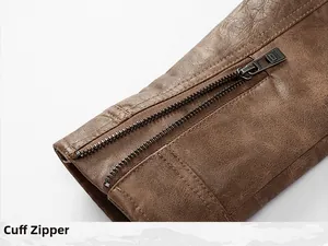 Close-up detail of the metal cuff zipper on a vintage brown leather biker jacket