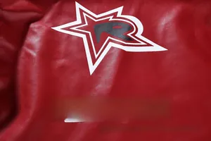 Close-up of red PU leather jacket with star embroidery and GANIRG text