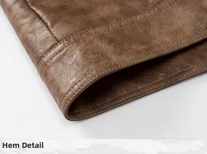 Close-up high-quality detail showing the durable stitched hem of a brown faux leather jacket