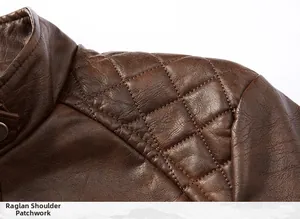 Macro detail showing quilted shoulder and raglan sleeve stitching on brown leather jacket