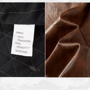 Close-up of brown faux leather texture and care label for men's motorcycle jacket.