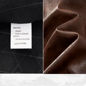 Macro detail showing brown faux leather texture and interior fabric care label.
