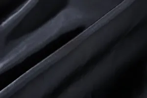 Macro view of black faux leather fabric texture showing fine grain for men's PU motorcycle jacket.