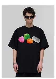 Close-up of black streetwear t-shirt with YOU NEED ME BABY candy pill print