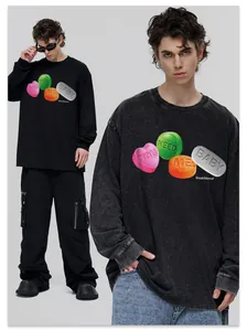 Close-up of streetwear long sleeve t-shirt with 'YOU NEED ME BABY' colorful graphic print.