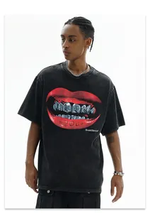 Model wearing a distressed washed black t-shirt with a bold red lip graphic print