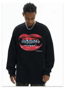 Front view of black oversized sweatshirt with bold red lips and grillz print detail.