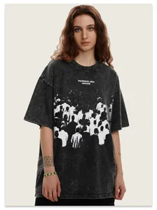 Close-up of oversized washed grey street style T-shirt with abstract crowd print detail