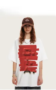 Detail of white street style t-shirt with 3D red tape graphic print and corduroy cap