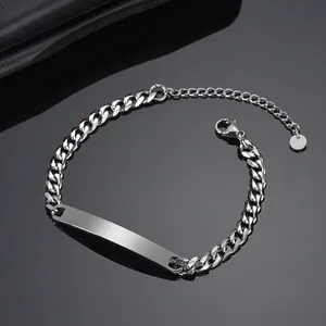 Close-up of minimalist stainless steel Cuban link bracelet with engravable blank bar