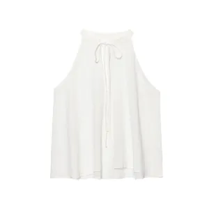 Detailed view of a white linen halter-neck top with front tie ribbon detail.