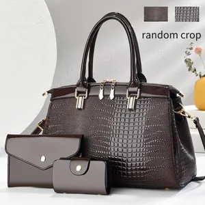 Brown crocodile-patterned three-piece bag set including Boston handbag and small wallets.