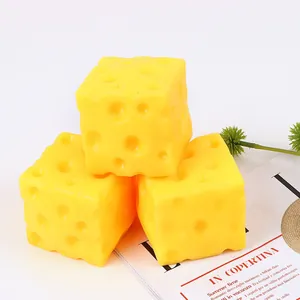 Close-up of three stacked yellow square cheese-shaped slow rebound squishy toys.