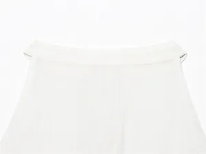 Detailed macro view of the minimalist white linen halter-neck top collar and texture.