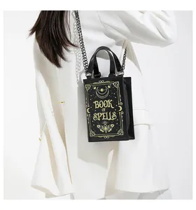 Detail view of the unique 'Book of Spells' gothic crossbody bag featuring gold motifs