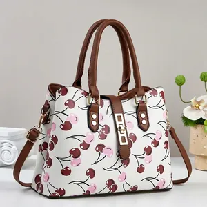 Detailed view of fashionable white handbag with sweet pink and red cherry patterns