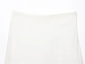 Detail view of white linen midi skirt waistband with invisible side zipper